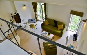 an overhead view of a living room with a green couch at Pieve Suites in Città della Pieve