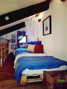 1 dormitorio con 1 cama grande con sábanas azules en Sur Un Petit Nuage en Roubion