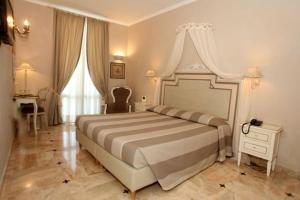 a bedroom with a bed and a dresser at Hotel La Colonnina in Monterosso al Mare