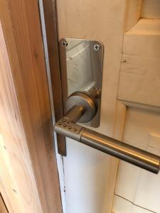 a metal door handle on a door in a room at Pajula B&B in Järvenpää
