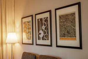 three framed pictures are hanging on a wall at Ferienwohnung Berlin in Berlin