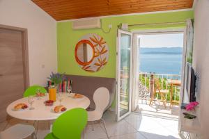 a dining room with a table and a view of the ocean at Apartment Ariana in Bol