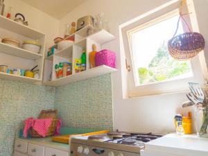 eine Küche mit Herd und Fenster in der Unterkunft Hostel Kapa in Hvar