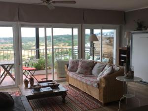 a living room with a couch and a balcony at Sea Views Penthouse in Sitges