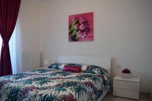 a bedroom with a bed and a painting on the wall at MC Malpensa Airport Home in Gallarate