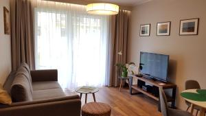 Televízia a/alebo spoločenská miestnosť v ubytovaní New apartment 100m from old town and marina
