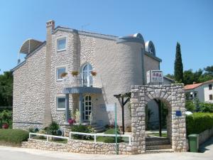 a large stone building with an arch in front of it at Apartments Ana - Rovinj in Rovinj