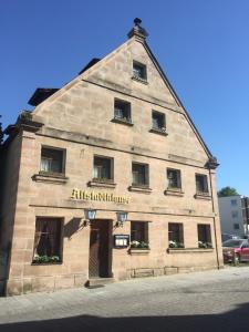 a large stone building with a sign on it at Altstadtpension Zirndorf in Zirndorf