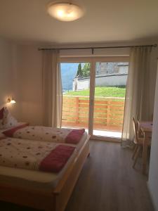 A bed or beds in a room at Gasthaus St. Valentin