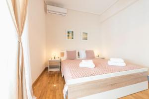 A bed or beds in a room at Stylish Athenian Flat