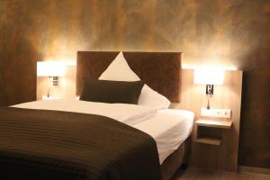 Ένα ή περισσότερα κρεβάτια σε δωμάτιο στο Hotel Baldus