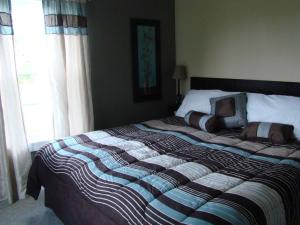 a bedroom with a large bed with a large window at The Chapman House in Lineville