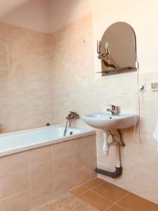 a bathroom with a sink and a bath tub at Baltic Vip Apartamenty Letnie w Rewalu in Rewal +16 photos