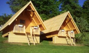 a large wooden house with two decks at farmglamping Planika - Encijan in Hraše
