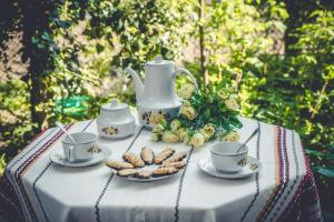 a table with cups and plates of food on it at Art Studio in Sapareva Banya