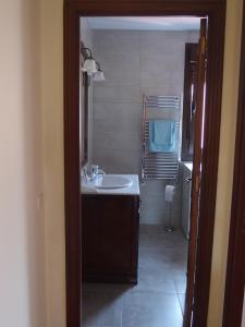 a bathroom with a sink and a mirror at Casa Grande de Borizu Playa in Celorio