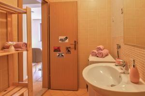 a bathroom with a sink and a toilet with towels at Apartment Borik in Pula +17 photos