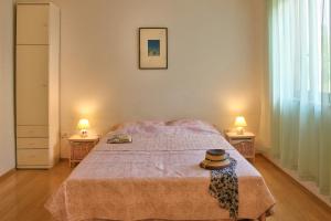a bedroom with a bed and two lamps on two tables at Apartment Borik in Pula