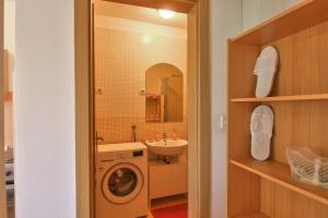 a bathroom with a sink and a washing machine at Apartment Borik in Pula