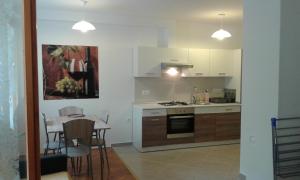 a kitchen with a table and a stove top oven at App Dalia Losinj in Mali Lošinj