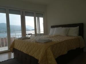 a bedroom with a bed with a view of the water at Vila Mare in Ohrid
