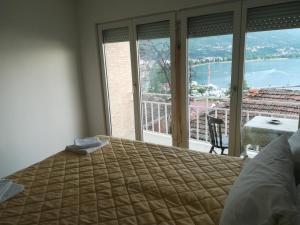 a bedroom with a bed and a window with a view at Vila Mare in Ohrid