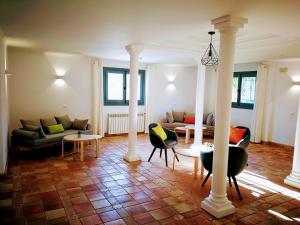 a living room with couches and chairs and tables at Hotel Ronda Moments in Ronda