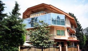 a house with a sign on the front of it at Hotel Aristocrat & Fish Restaurant in Skopje