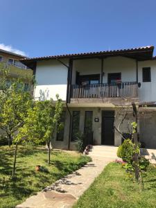 a house with a balcony and a walkway at Villa Dimi in Sinemorets