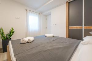 Posteľ alebo postele v izbe v ubytovaní Apartment Hektor