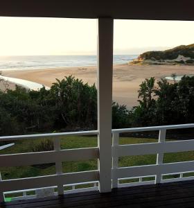 a view of the beach from the porch of a house at Gill's Beach House in Chintsa