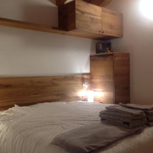 Un dormitorio con una cama blanca con luz. en Rooms dei Minatori, en Pergine Valsugana