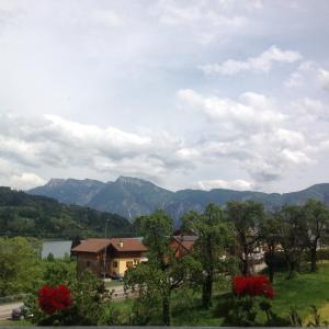 a view of a house with mountains in the background at Rooms dei Minatori in Pergine Valsugana +23 photos
