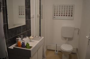 a bathroom with a white sink and a toilet at Kućica [kȕtɕitsa] - small house with free parking in Zagreb