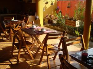 a wooden table and chairs on a patio at Hotel da Gaúcha in Tucuma