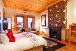 a bedroom with a large bed and a fireplace at Wilton Manor SOLAR ENERGY in Cape Town +84 photos
