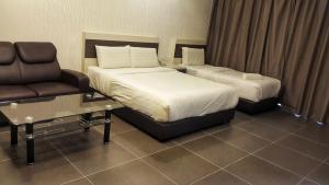 Postel nebo postele na pokoji v ubytování Kampar Boutique Hotel (Kampar Sentral)
