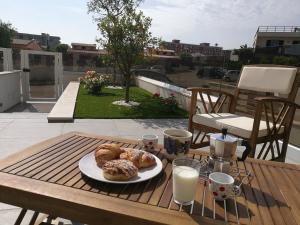 a plate of pastries on a table on a patio at Manolo Case Vacanza in Monopoli