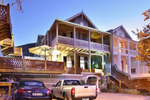 a building with cars parked in front of it at Wilton Manor SOLAR ENERGY in Cape Town