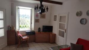 een woonkamer met een televisie en een raam bij Location Turistic Antica dimora di Campagna Cir 00012 in Grazzano Badoglio