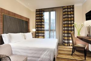 A bed or beds in a room at Uptown Palace