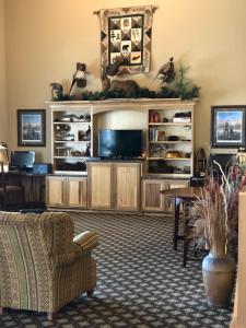 a living room with a large entertainment center with a television at AmericInn by Wyndham Princeton IL in Princeton