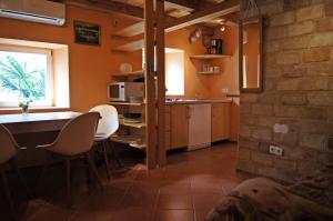 a kitchen with a table and chairs in a room at Cherso Mare in Cres