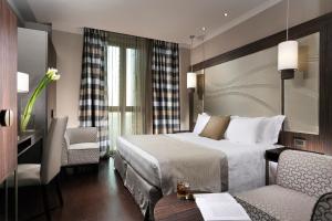 A bed or beds in a room at Uptown Palace