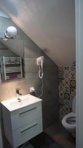 a bathroom with a sink and a mirror and a toilet at Apartamenty Oaza in Rewal +147 photos