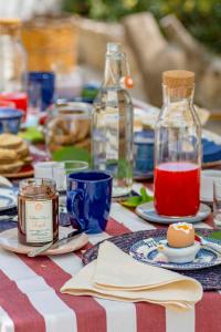 a table with a red and white table cloth with bottles at fuoridalgusciohome in Leuca