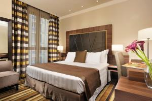 A bed or beds in a room at Uptown Palace