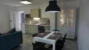 a kitchen with a table and chairs and a couch at Apartamenty Oaza in Rewal