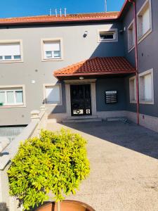 a house with a plant in front of it at the Beach House in A Pobra do Caramiñal