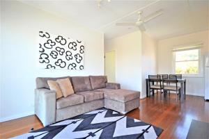 a living room with a couch and a table at Breakers 6 2 Hill Street in Port Macquarie